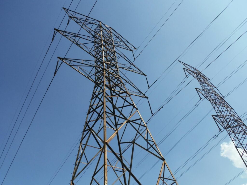 High voltage power lines against blue sky